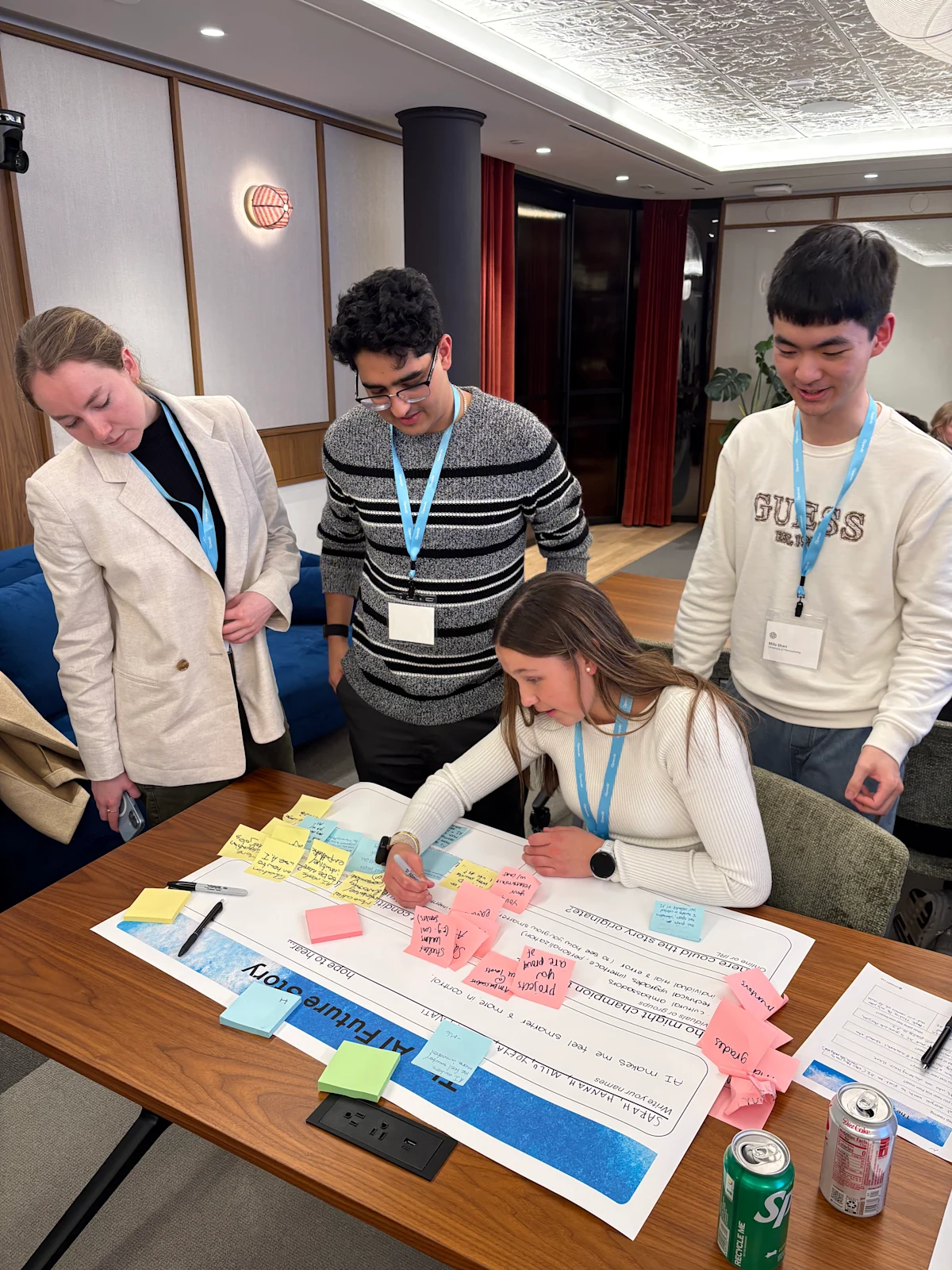 Students collaborating around a table at an OpenAI community event.